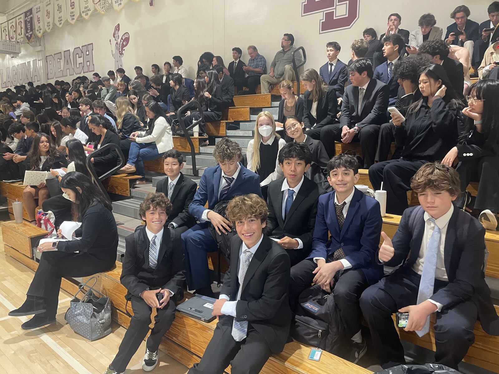 Thurston delegates sitting together on the bleachers in the Laguna Beach High School gym